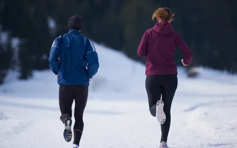 Young couple on a run during the winter.